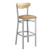 A Lancaster Table & Seating bar stool with a wooden back and seat and metal frame.