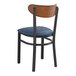 A Lancaster Table & Seating Boomerang Series black chair with navy vinyl seat and antique walnut back.