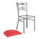 A Lancaster Table & Seating cross back chair with a red cushion on a white surface.