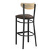 A Lancaster Table & Seating black metal bar stool with a driftwood back and dark brown cushion.