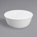 An Elite Global Solutions white melamine bowl on a gray surface.