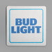 A close-up of a white square coaster with a blue Bud Light logo.