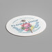 A round white paper coaster with a flower design on it.