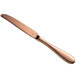 A close-up of a Reserve by Libbey Santa Cruz copper dinner knife with a rose gold handle.