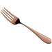 A close-up of a Reserve by Libbey Santa Cruz copper salad fork with a rose gold handle.