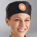 A smiling woman wearing a black Choice Cloth Top Chef Skull Cap.