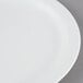 A close-up of a Cambro white polycarbonate plate with a narrow white rim.