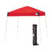 A red E-Z Up Vista canopy with a white frame and a black bag on the side.