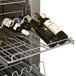 A Traulsen wine refrigerator with wine bottles on a rack.