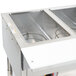 An APW Wyott stainless steel hot food warmer with three pans on a counter.