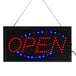 A white rectangular LED sign that says open in red and blue italic letters.