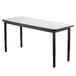 A rectangular white table with black legs.