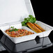 A white Genpak foam container with 2 compartments filled with food.