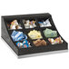 A black wooden Cal-Mil condiment organizer with nine compartments filled with a variety of condiments.
