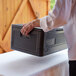 a person holding a black box