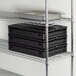 A black CaterGator food pan carrier with metal trays inside.