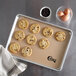 A chocolate chip cookie on a Choice silicone baking mat.