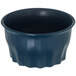 A dark blue Dinex convection bowl with wavy edges.
