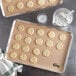A tray of cookies on a Choice Full Size Silicone baking mat.