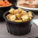 A bowl of potatoes and carrots in a Dinex Tropez convection bowl.