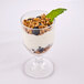 A GET SAN plastic goblet filled with yogurt topped with granola and blueberries.
