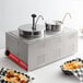 An Avantco countertop food warmer with two pots and bowls of chips and cheese.