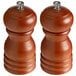 Two Acopa wooden salt and pepper mills with metal lids.