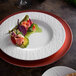 A white Villeroy & Boch porcelain coupe plate with food on it on a table.