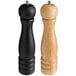 Two Acopa pepper mills with wooden handles, a black base, and a natural wood top.