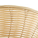 A close up of a Thunder Group rattan bread basket.