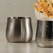 Two American Metalcraft stainless steel cups filled with french fries.