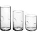 Acopa Thumbprint Rocks and Old Fashioned Beverage Glasses with different shapes and sizes on a white background.