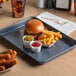 A Baker's Mark quarter size non-stick bun/sheet pan with a burger and fries on it.