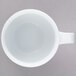 A 10 Strawberry Street Taverno white porcelain mug with a handle.