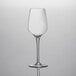 A clear Chef & Sommelier wine glass on a white surface.