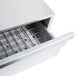 A stainless steel APW Wyott Dry Hot Dog Bun Warmer drawer with a grate on top.