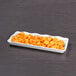 A white Elite Global Solutions rectangular melamine tray filled with diced food on a counter.