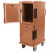 A coffee beige Cambro Ultra Camcart food pan carrier with the door open.