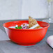 A bowl of soup with a piece of food on it in a RAK Porcelain Neo Fusion Ember Red bowl.