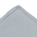A folded gray cloth with a small hole in it.
