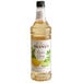 A Monin Premium Exotic Citrus Flavoring Syrup label on a bottle of liquid.