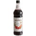 A bottle of Monin Premium Tart Cherry flavoring syrup with a white label.