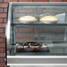 A Vollrath curved glass drop in refrigerated countertop display case with a variety of desserts inside.