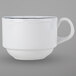 A white Tuxton china cup with a scalloped edge and a black rim with a blue line.