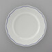 A Tuxton white china plate with scalloped edges and blue trim.