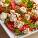 A plate of tomatoes and feta cheese.