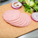 Sliced Taylor Provisions mild pork roll and onions on a cutting board.