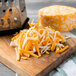Shredded Laubscher Colby Jack cheese on a cutting board.
