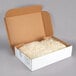 A box containing two white plastic bags of feta cheese crumbles.