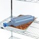 A blue plastic San Jamar Rapi-Kool container on a counter in a professional kitchen.